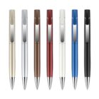 A row of seven ballpoint pens in various colors including gray, silver, brown, red, white, blue, and black, each with a metallic clip and tip, arranged against a white background.