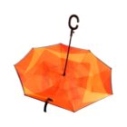 A bright orange inverted umbrella with a C-shaped handle is shown. The umbrella is open, displaying its unique reverse structure that folds outward.
