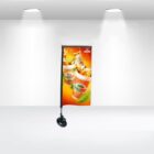 A promotional stand with a bright orange banner displaying images of fruit juice cans, ice cubes, and fruit slices. The banner is set against a minimalist white background, illuminated by ceiling lights.