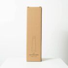 A cardboard box with a minimalist illustration of a water bottle on its front. It reads Lotus Water Bottle, indicating a capacity of 500ML or 17 OZ. The box is standing upright on a plain white surface against a neutral background.