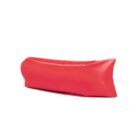 A red inflatable lounge sofa is positioned against a plain white background. It has a sleek, curved design with a smooth surface, likely intended for outdoor relaxation.