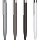 Four sleek ballpoint pens stand in a row. The pens are silver, brown, black, and white, each with a metallic clip. The design is minimalist and modern.