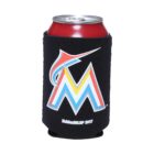A red soda can sits inside a black koozie that features a colorful logo resembling the letter M overlaid with a marlin fish outline. The koozie has Kolder/MLBP 2017 printed below the logo in white letters.