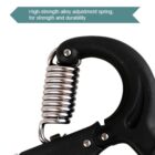 Close-up of a gripper exercise tool with a high-strength alloy adjustment spring, designed for strength and durability. The tool has a black handle and silver coil spring. A label at the top highlights its features.