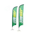 Two green vertical feather flags with the word Subway in yellow and white letters. The flags have black edges and stand on metal bases.