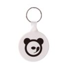 A round white keychain with a metal ring features a black, stylized panda face design.