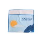 A blue cloth with a printed design featuring a sun, clouds, and the text ADIO in bold letters. It has blue edging and a stitched border.