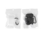 Two sealed plastic packages, each containing an earbud case and a carabiner. The left package holds a white case, and the right one has a black case. The packages are transparent, allowing the contents to be clearly visible against a plain background.