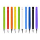 A row of ten ballpoint pens arranged vertically. The pens have caps and come in various colors: green, red, orange, yellow, lime green, white, blue, light blue, black, and purple. Each pen has a metallic tip.