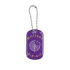 Purple dog tag with Military Brat written in yellow around a white dandelion graphic. The tag is attached to a silver ball chain.