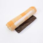 Rolled-up blanket with an orange and yellow geometric pattern, partially unrolled on a brown and white backing, against a white background.