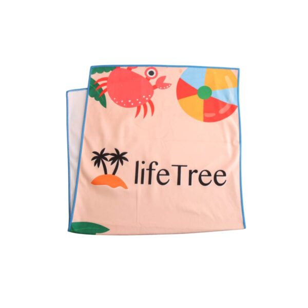 A beige beach towel with a blue border, featuring a cartoon crab, palm trees, an island, and a colorful beach ball. The text lifeTree is printed in black on the towel.