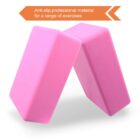 Two pink yoga blocks at an angle against a white background. An orange label in the upper left corner reads: Anti-slip, professional material for a range of exercises.