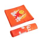 Two orange fabric pieces: one folded flat showing a design of a basketball with abstract figures, and the other rolled up displaying partial text. The designs feature vibrant colors and sports themes.