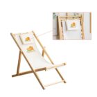 A wooden deck chair with a white fabric seat featuring an orange house and RESIDENTIAL text. An inset magnifies the logo. The chair is positioned on a light background with blurred wall art in the back.