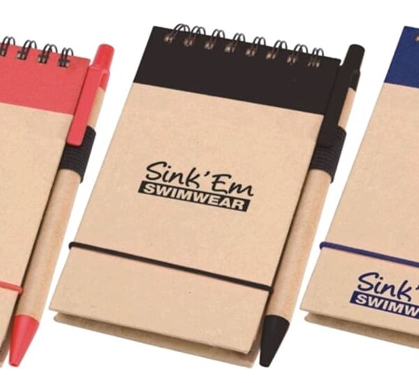 Three small notepads with spiral bindings, each with a pen attached. The covers are brown with colored tops: red, black, and blue. The text Sink Em Swimwear is printed on each notepad.