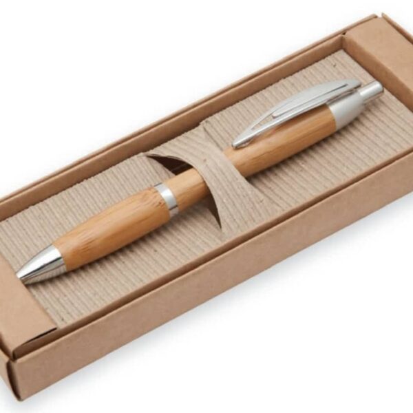 A bamboo pen with silver accents is displayed in a cardboard box. The box has a corrugated interior, holding the pen securely.