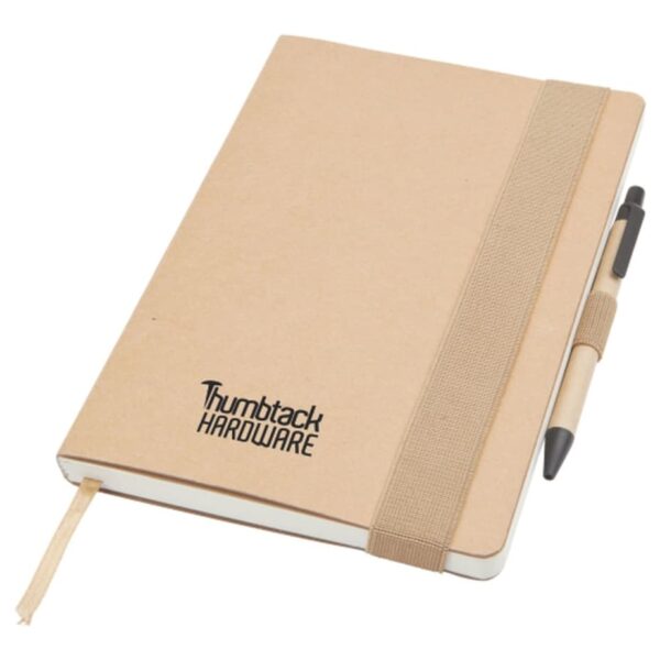 A brown notebook with Thumbtack Hardware printed on the cover, featuring an elastic band closure and a pen loop holding a black-tipped pen. A fabric bookmark is attached to the notebook.