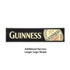 Rubber bar mat featuring the Guinness logo in white on a black background. The mat includes a circular Guinness label design on the right. Text below reads: Additional Service: Larger Logo Shape.