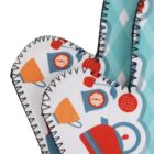 Close-up of fabric oven mitts with a stitched border. One mitt features a pattern of colorful kitchenware including teapots and cups. The other has a teal pattern with diamonds and geometric shapes.