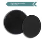 Two round black exercise sliders, one large and one small, placed side by side. A text above reads, Hard material one side, soft on other with an arrow symbol.