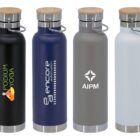 Four stainless steel water bottles with wooden caps in black, blue, gray, and white. Each bottle features a different logo on the front.