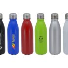 Six colorful reusable water bottles with stainless steel caps are lined up. The bottles are black, blue, red, green, silver, and white. Each bottle features a unique logo on the front, showcasing different designs and text.