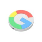 A round device featuring the Google logo, composed of red, yellow, green, and blue segments, on a white background. Theres a small port on the edge of the device.