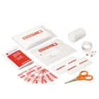First aid kit contents including adhesive bandages, gauze pad, adhesive tape, safety pins, small scissors, and antiseptic wipes, arranged on a white surface.