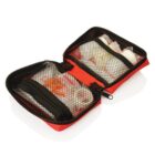 A red first aid kit opened to show mesh pockets containing various medical supplies, such as bandages and small containers. The interior is organized with visible zipped compartments, set against a white background.