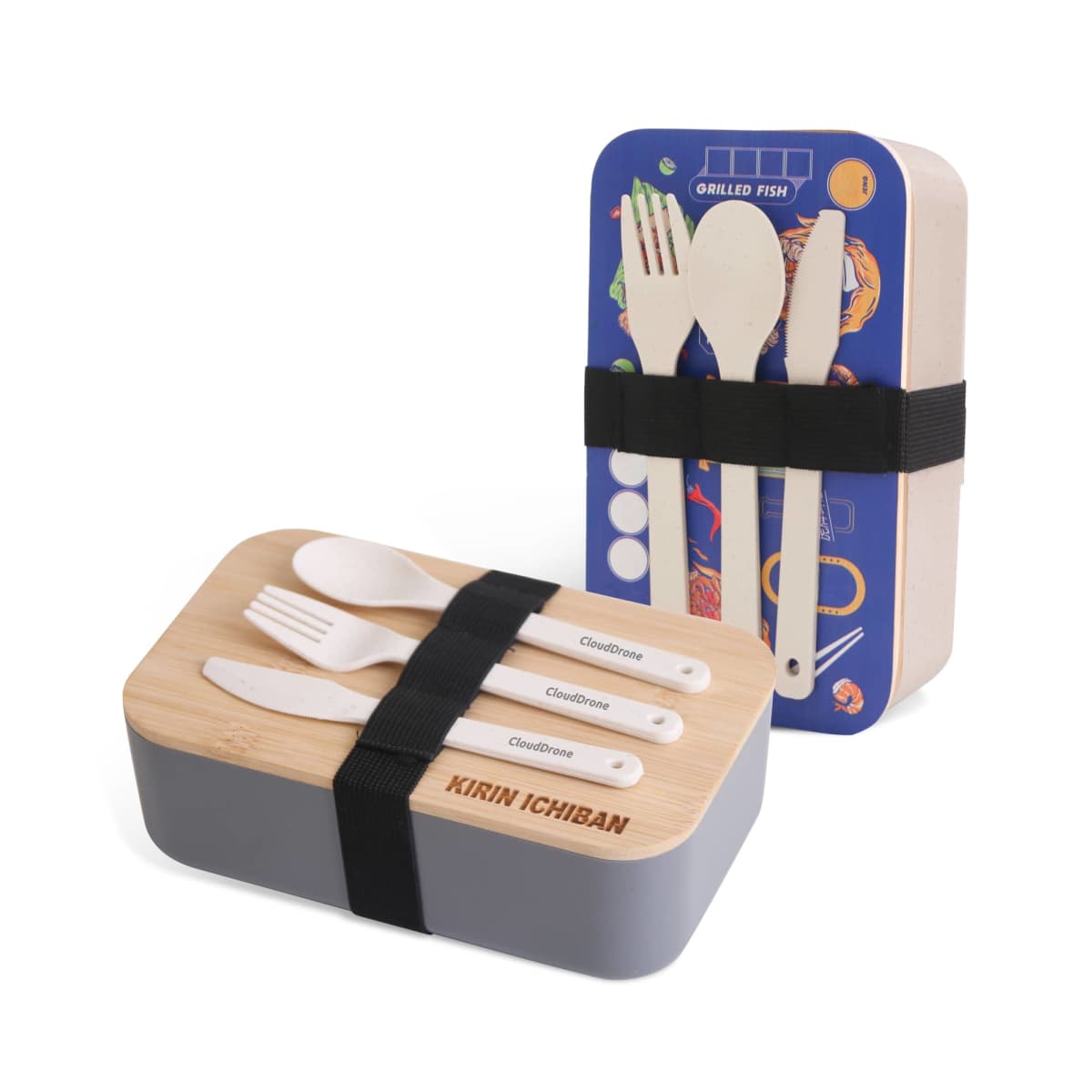 Two bento lunch boxes with cutlery sets. One box is gray with wooden forks and spoons, the other has a colorful fish-themed lid. Both have utensils secured with an elastic strap.