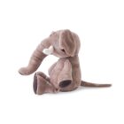 Side view of a plush elephant toy with brown fur and white tusks, sitting on a white background.