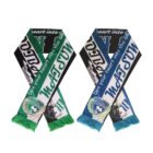 Two colorful sports scarves are crossed, featuring green, blue, and white stripes. They have fringe at the ends and display team logos and the phrase Dye your heart into the GP prominently.