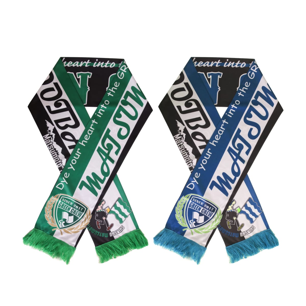 Two colorful sports scarves are crossed, featuring green, blue, and white stripes. They have fringe at the ends and display team logos and the phrase Dye your heart into the GP prominently.