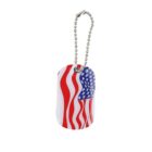 Dog tag with a design featuring the American flag, showing red and white stripes and a section of blue with white stars. It is attached to a silver ball chain.