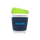 A reusable clear cup with a blue silicone sleeve and a bright green lid. The word escale is printed on the sleeve in blue. The lid has a drinking spout designed for easy sipping.