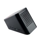 A black, triangular Bluetooth speaker with a perforated grille is angled to the right. It features a USB port, micro USB port, and an on/off button on its side, all set against a plain white background.