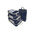 A set of four blue packing cubes with beige handles stacked neatly beside a matching blue zippered bag with a black handle.