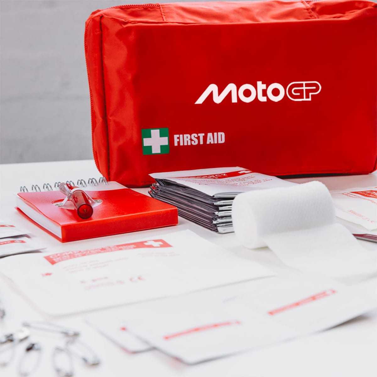 Red MotoGP first aid kit with supplies.