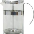 A clear glass French press with a metal lid and handle. The plunger is visible inside the cylindrical container, ready for use in making coffee or tea. The design is simple and modern with a polished metal finish.