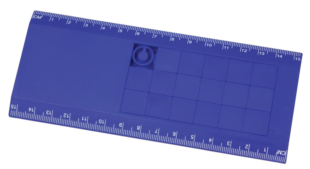 A blue stencil tool featuring a ruler on the top and bottom edges. It includes a grid of squares and a circle cutout in the upper right area. Numbers on the rulers range from 1 to 15 centimeters.