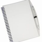 An open spiral-bound notebook with a blank white cover lies on a white surface. A silver pen is clipped to the front cover on the right side.