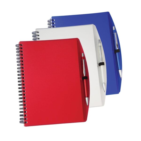 Three spiral notebooks with pens are displayed. They are red, white, and blue with matching pens attached to the covers by elastic loops. The notebooks are stacked slightly offset, showcasing each color.