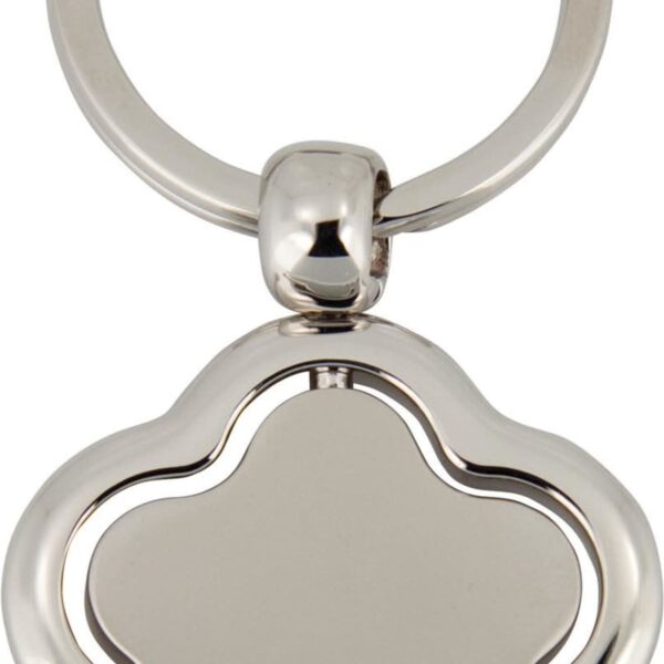 Close-up of a silver metal keychain with a flower-shaped pendant featuring smooth, rounded edges. The pendant has a minimalist design with a plain, reflective surface.