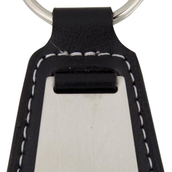 A keychain with a metal plate and a black leather base. The leather has white stitching along the edges. The metal ring is attached at the top of the leather section.