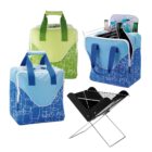 Colorful cooler bags in green and blue, with geometric patterns, featuring varying handle designs. One bag is open, showing beverages inside. A compact, portable grill is set up nearby.
