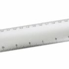 A silver metallic ruler with both centimeter and millimeter markings. The ruler is lying on a white surface, and the numbers range from 1 to 30 centimeters.