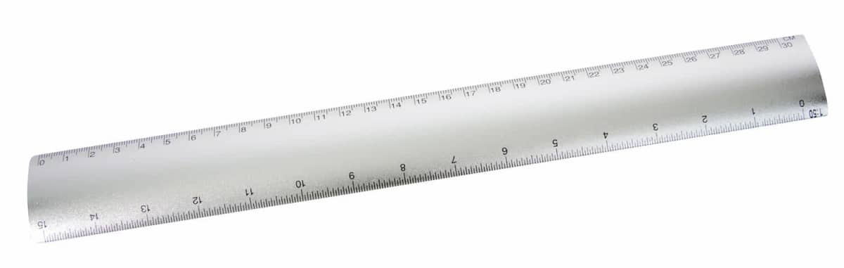A silver metallic ruler with both centimeter and millimeter markings. The ruler is lying on a white surface, and the numbers range from 1 to 30 centimeters.