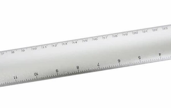 A silver metallic ruler with both centimeter and inch measurements. The ruler is angled slightly and has numbers marking each unit of measurement along the edges.