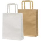 Two plain paper bags with handles stand side by side against a white background. The bag on the left is white, and the bag on the right is brown.